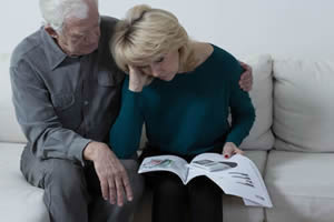 An older couple discussing something difficult; Medicaid Crisis Planning