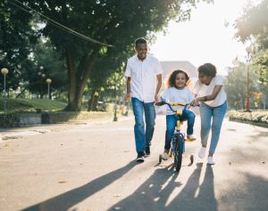 incentive trust, image of parents teaching child to ride a bike