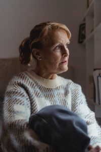 revocable living trust, image of middle-aged woman sitting alone, gazing in apparent thought